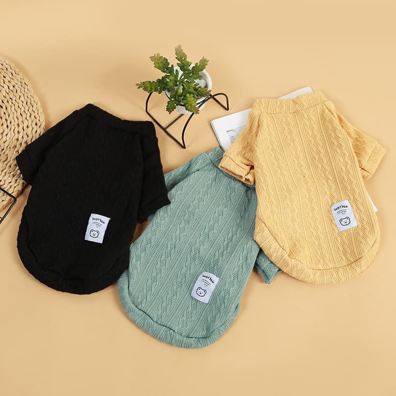 Black green and yellow bear knit pet sweaters arranged together