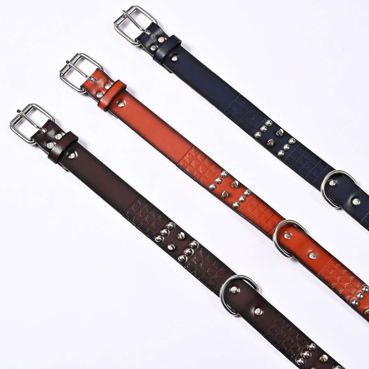 Black brown and chestnut studded PU dog collars arranged in a row