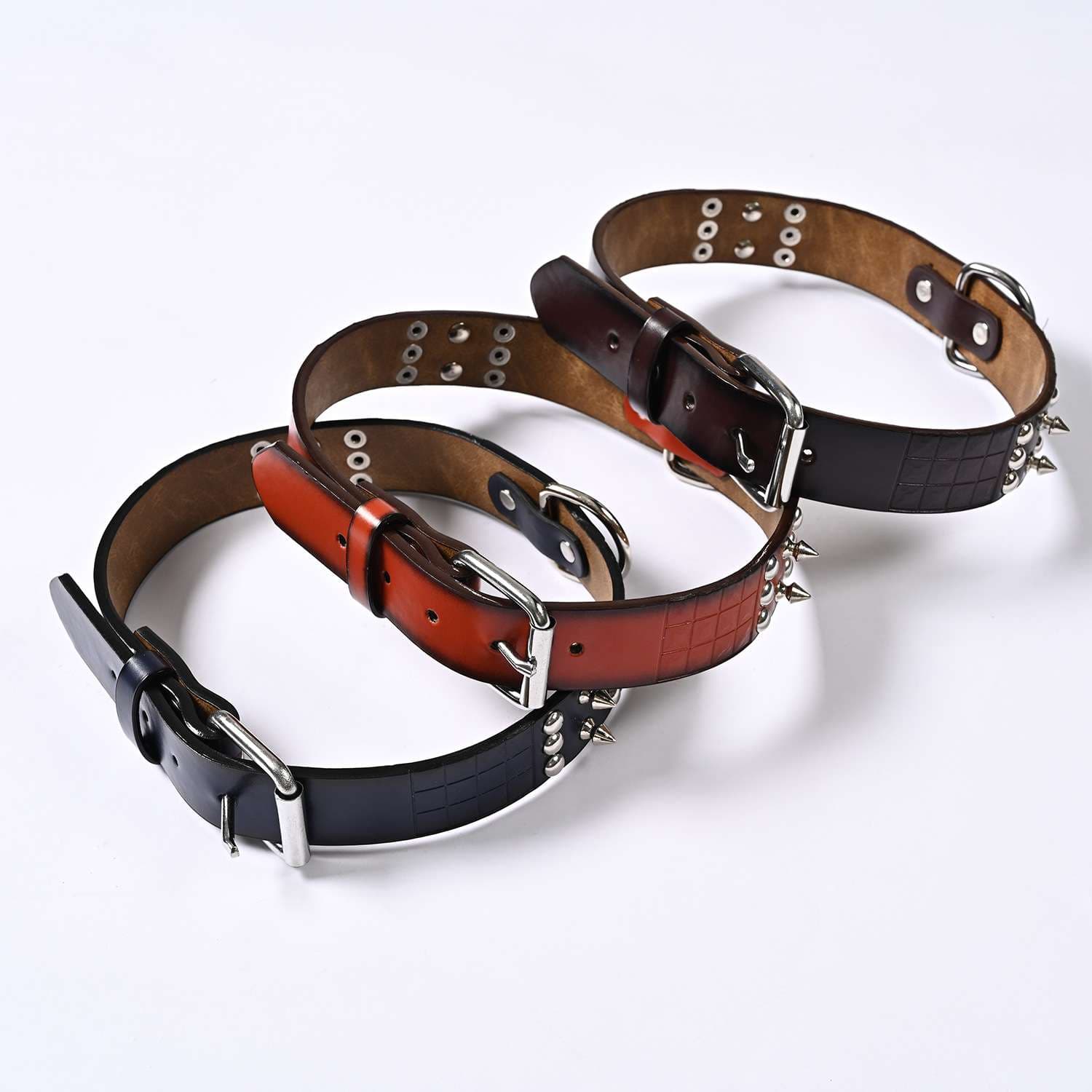 Three wide studded PU dog collars showing the buckle and D-ring profile